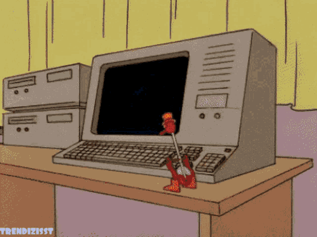 A toy drinking bird bobbing up and down to repeatedly press a key on a computer keyboard